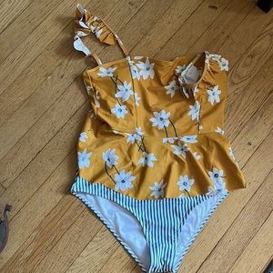 Adorable two piece coordinating swimsuit. Top is floral/bottoms striped. Size L